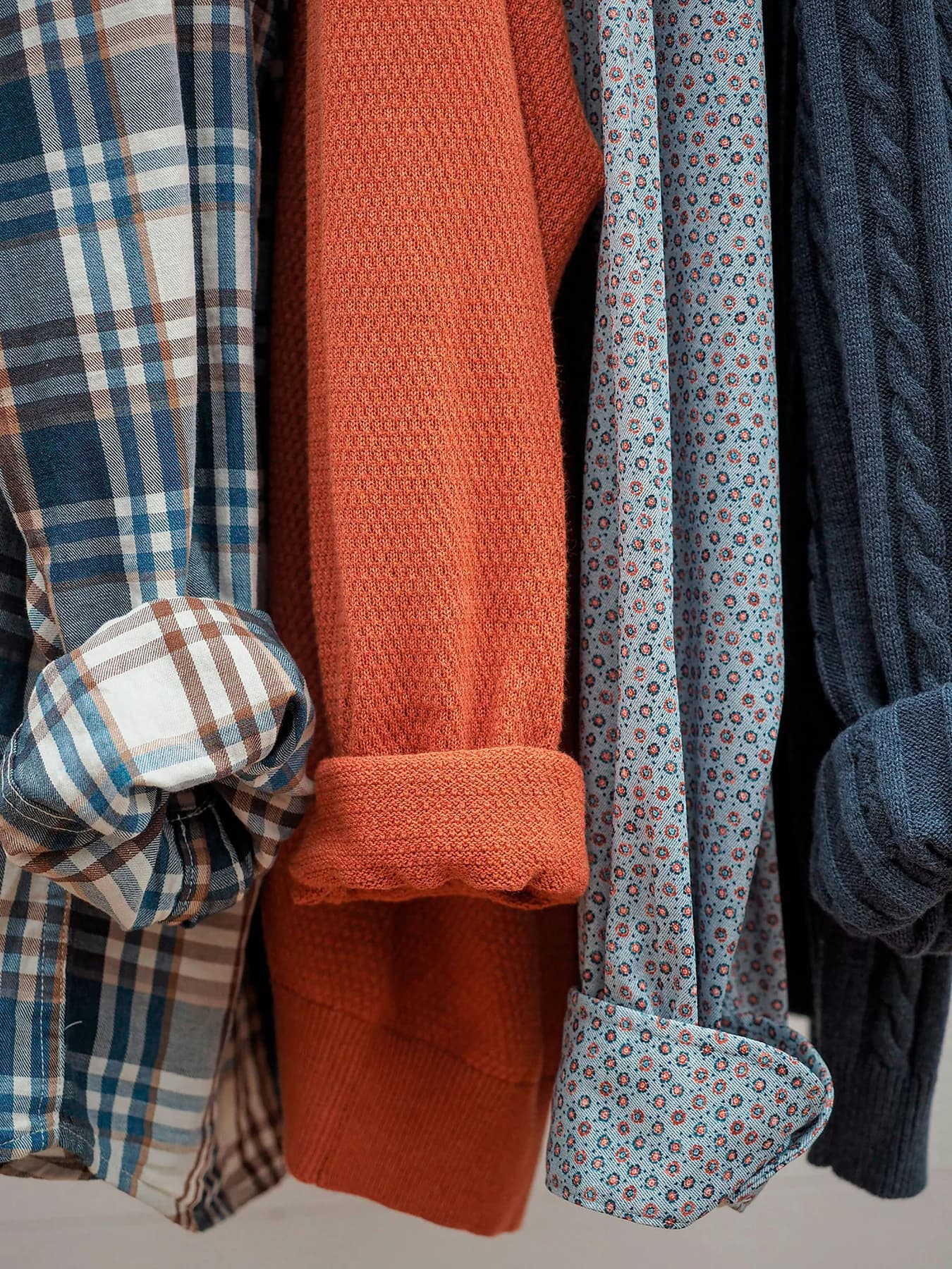 A close study of layered textiles on a wardrobe rail