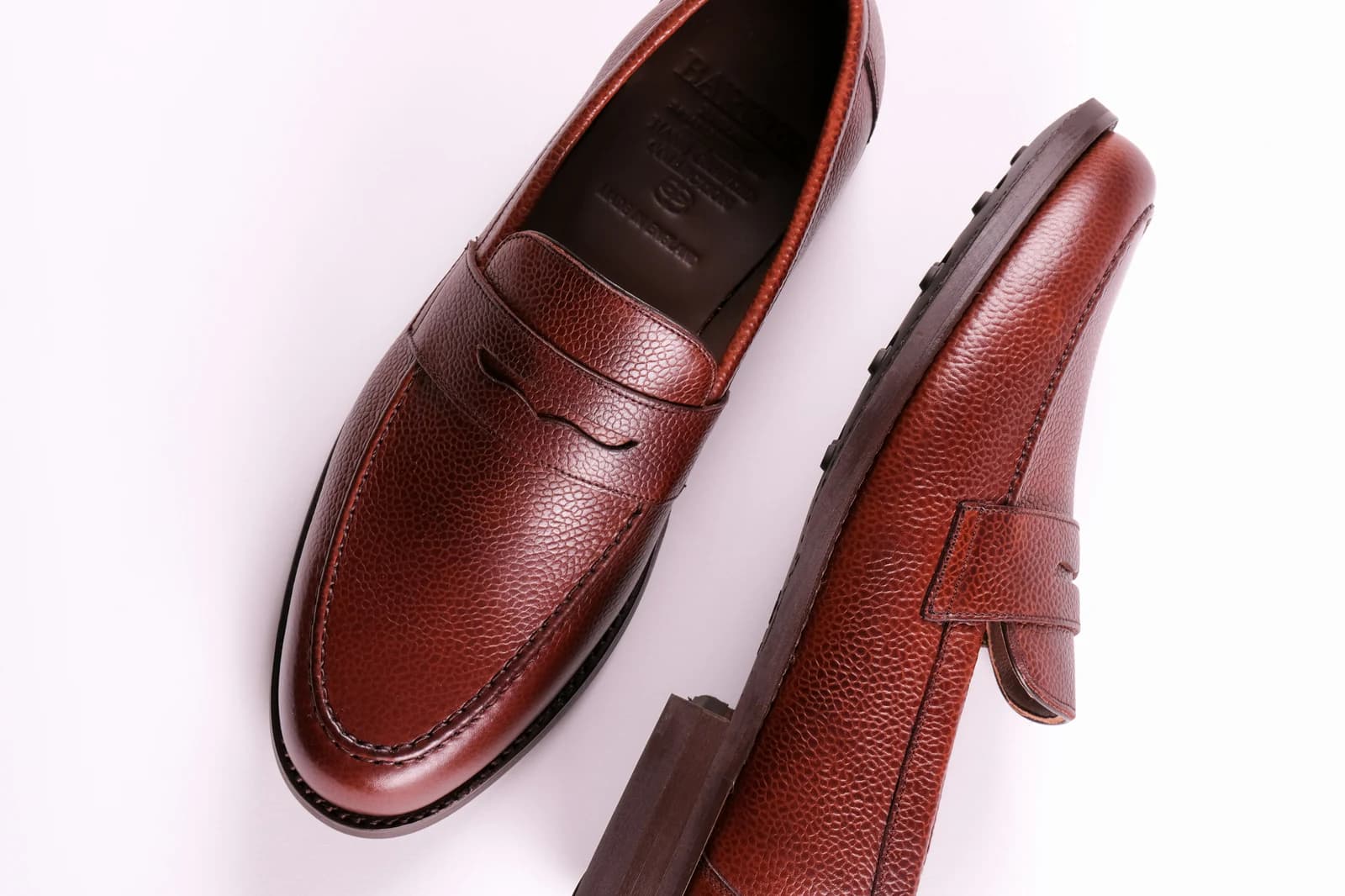 Oxblood loafers beneath a clean trouser hem