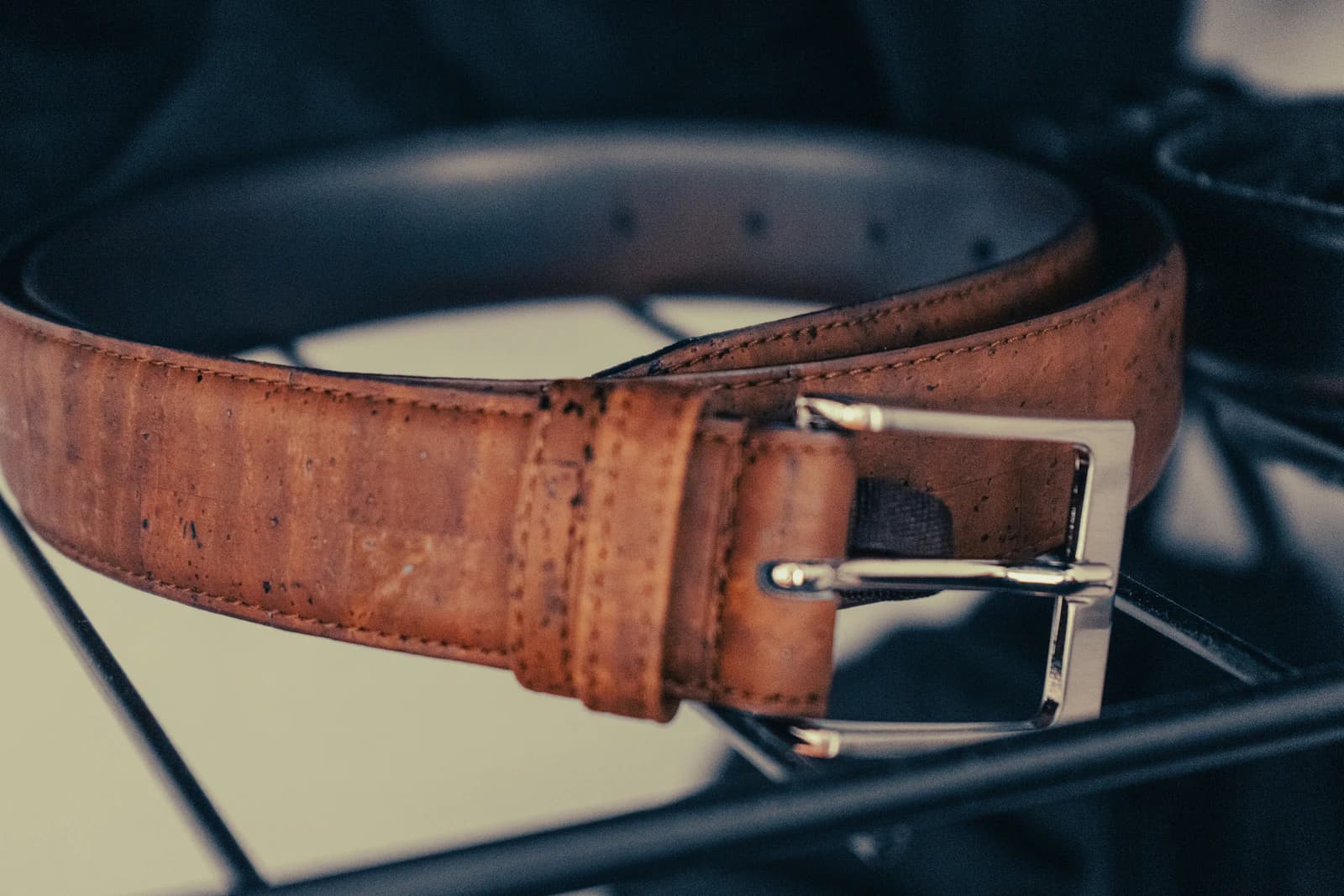 A brown leather accessory shown as a versatile connecting piece