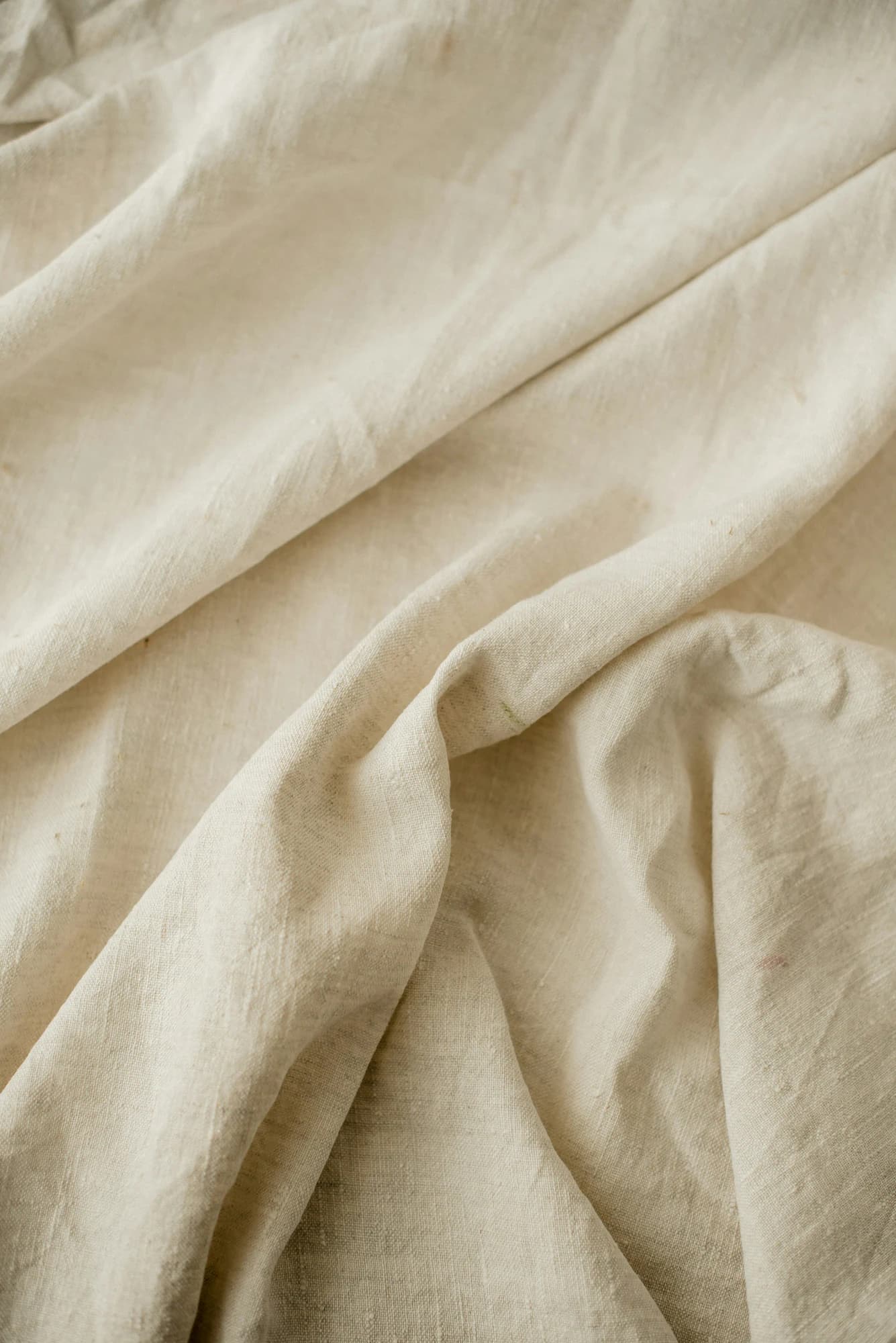 Natural cream fabric showing subtle variation in texture and tone